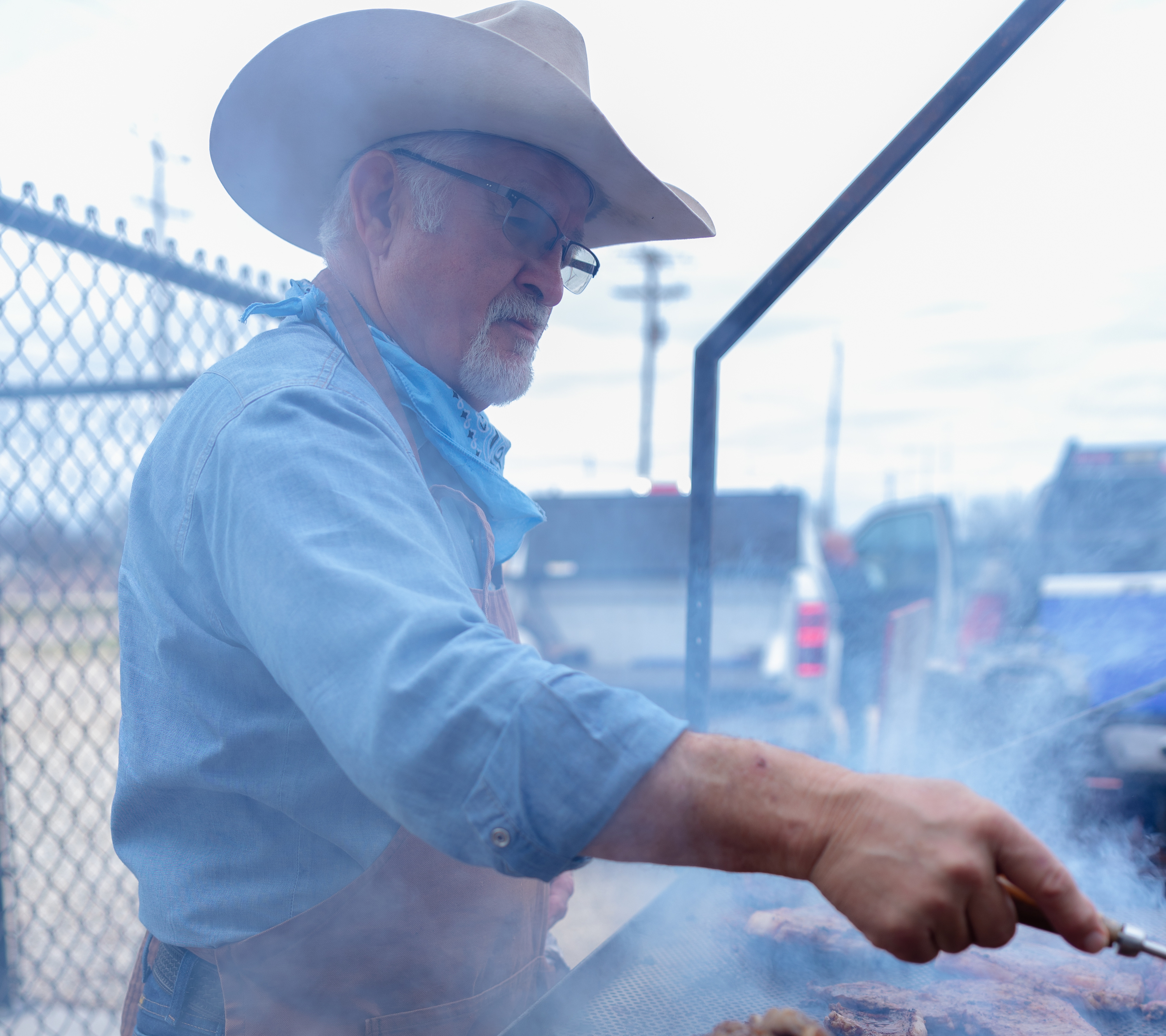 Photo of a man grilling steaks